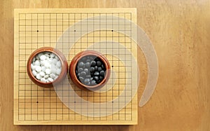 Goban, Baduk, Weiqi or Maklom - Traditional asian strategy board game. black and white stone of Chinese board game