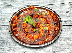 gobi manchurian served in dish isolated on wooden table top view of indian spicy food