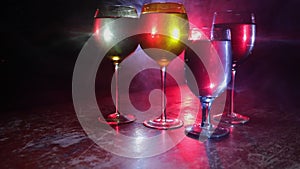 Goblet of white wine on wooden table on wooden wall background