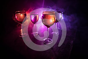 Goblet of white wine on wooden table on wooden wall background