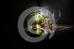 Goblet of white wine on wooden table on wooden wall background