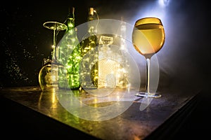 Goblet of white wine on wooden table on wooden wall background