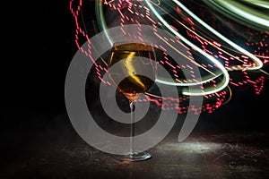 Goblet of white wine on wooden table on wooden wall background