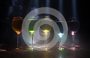 Goblet of white wine on wooden table on wooden wall background