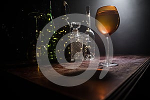 Goblet of white wine on wooden table on wooden wall background