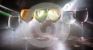 Goblet of white wine on wooden table on wooden wall background
