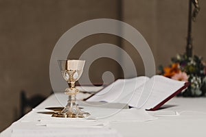 Goblet of wine on table during a wedding ceremony nuptial mass. Religion concept