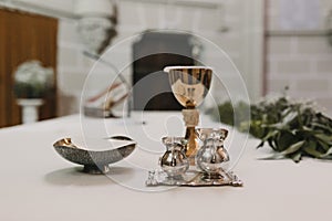 Goblet of wine on table during a wedding ceremony nuptial mass. Religion concept. Catholic eucharist ornaments for the celebration