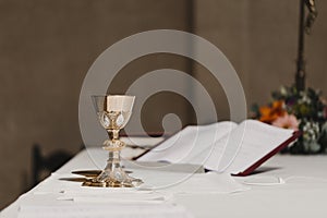 Goblet of wine on table during a wedding ceremony nuptial mass. Religion concept photo