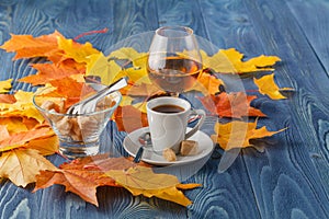 Goblets of brandy and cup of hot coffeeon wooden old counter top