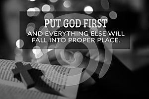God inspirational quote - Put God first and everything else will fall into proper place. With holy cross person reading bible book photo