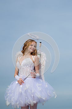 The God of Love. Concept of Valentines Daygirl dressed as an angel on a light background. Toddler girl wearing angel