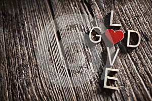 God and love words written in the shape of a religious cross background