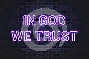 In God We Trust, the official motto of the United States glowing violet neon letters on a black brick wall