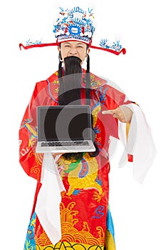 God of wealth holding a laptop over white