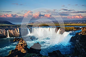 Godafoss waterfall at sunset. Fantastic landscape. Beautiful cumulus clouds. Iceland