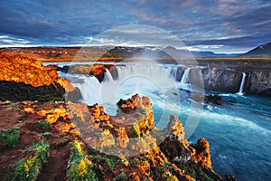 Godafoss waterfall at sunset. Fantastic landscape. Beautiful cumulus clouds. Iceland Europe