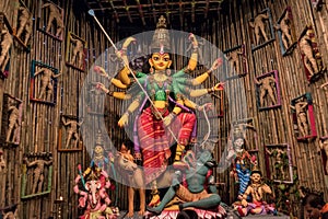 Goddess Durga idol at decorated Durga Puja pandal, shot at colored light, at Kolkata, West Bengal, India. Durga Puja is biggest