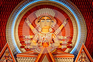 Goddess Durga idol at decorated Durga Puja pandal, shot at colored light, in Kolkata, West Bengal, India. Durga Puja is biggest