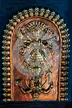 Goddess Durga killing demon Asura, Terracotta framed show piece displayed photo
