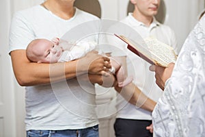 Godfather caucasian young man holding little infant kid in bap