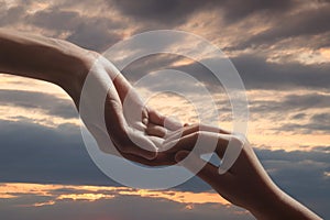 Godparent with child and beautiful sky with clouds at sunset on background, closeup photo