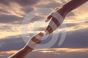 Godparent with child and beautiful sky with clouds at sunset on background, closeup photo