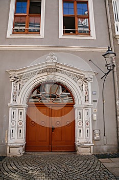 Goerlitz, Saxony, Germany, 04 September 2021: antique renaissance portal, floral ornaments, entrance to house at sunny summer day