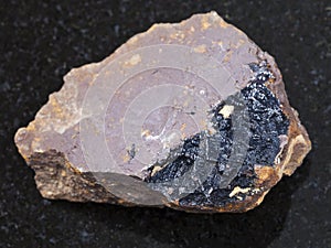 goethite aggregates on limonite rock on dark photo