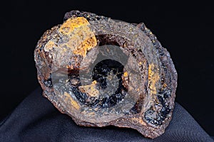 Goethite geode hydrogoethite in limonite on a black background, iron ore