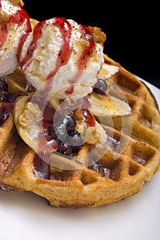 Gofre - belgian homemade waffles with ice cream, bananas and nuts photo