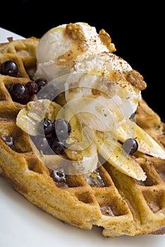 Gofre - belgian homemade waffles with ice cream, bananas and nuts photo