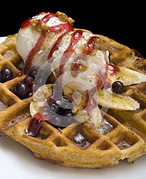 Gofre - belgian homemade waffles with ice cream, bananas and nuts photo
