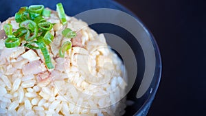 Gohan rice in a black bowl side view