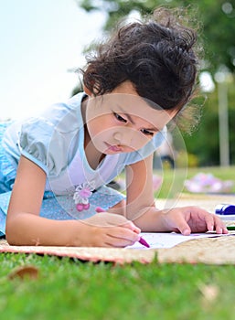 Going back to school,Girl drawing and painting over green grass