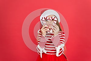 Going crazy on party. festive party in red color. sweet childhood. small girl having fun. santa elf kid candy cane decor