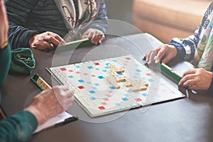 Going for the seven letter word. seniors playing a boardgame.