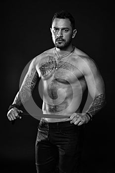 Going to punish you. Fashion model with leather belt. Man with tattoo. Bearded man with muscular torso. Sportsman with