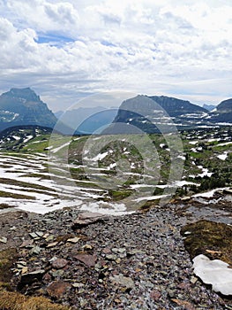 Going to the Sun Road, View of Landscape, snow fields In Glacier National Park around Logan Pass, Hidden Lake, Highline Trail, whi