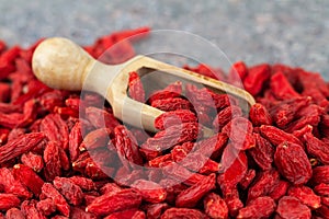 Goji berries close-up. Scoop with dried gougizi berries, selective focus