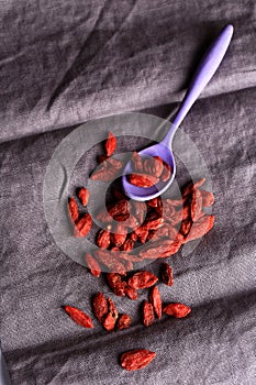 Goji berries on a dark linen background selective soft focus photo