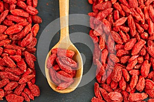 Goji berries over gray slate background. Healthy food concept