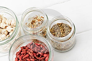 Goji berries and sprouts in glass jars