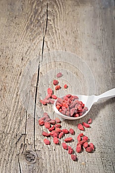 Goji berries in wooden spoon, selective focus