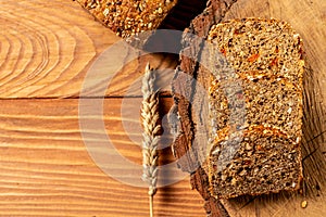 Goji berry bread. Sliced rye bread on a wooden stump, with wheat. Whole grain rye bread with seeds, walnut. healthy food concept.