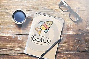 Golas text on notepad and coffee