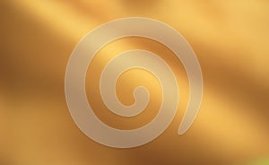 Gold abstract background with some smooth highlights and folds in it so that the center of the image is blurred