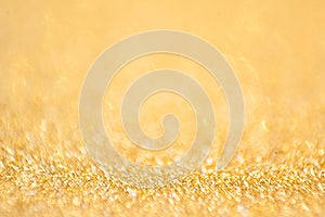 Gold abstract bokeh glitter texture background, filled with shiny gold glitter background. selective focus