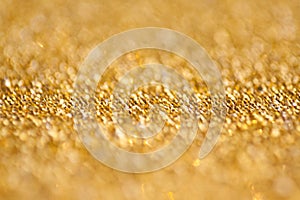 Gold abstract bokeh glitter texture background, filled with shiny gold glitter background. selective focus