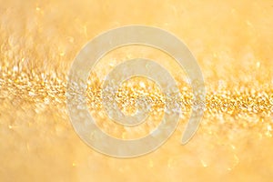 Gold abstract bokeh glitter texture background, filled with shiny gold glitter background. selective focus